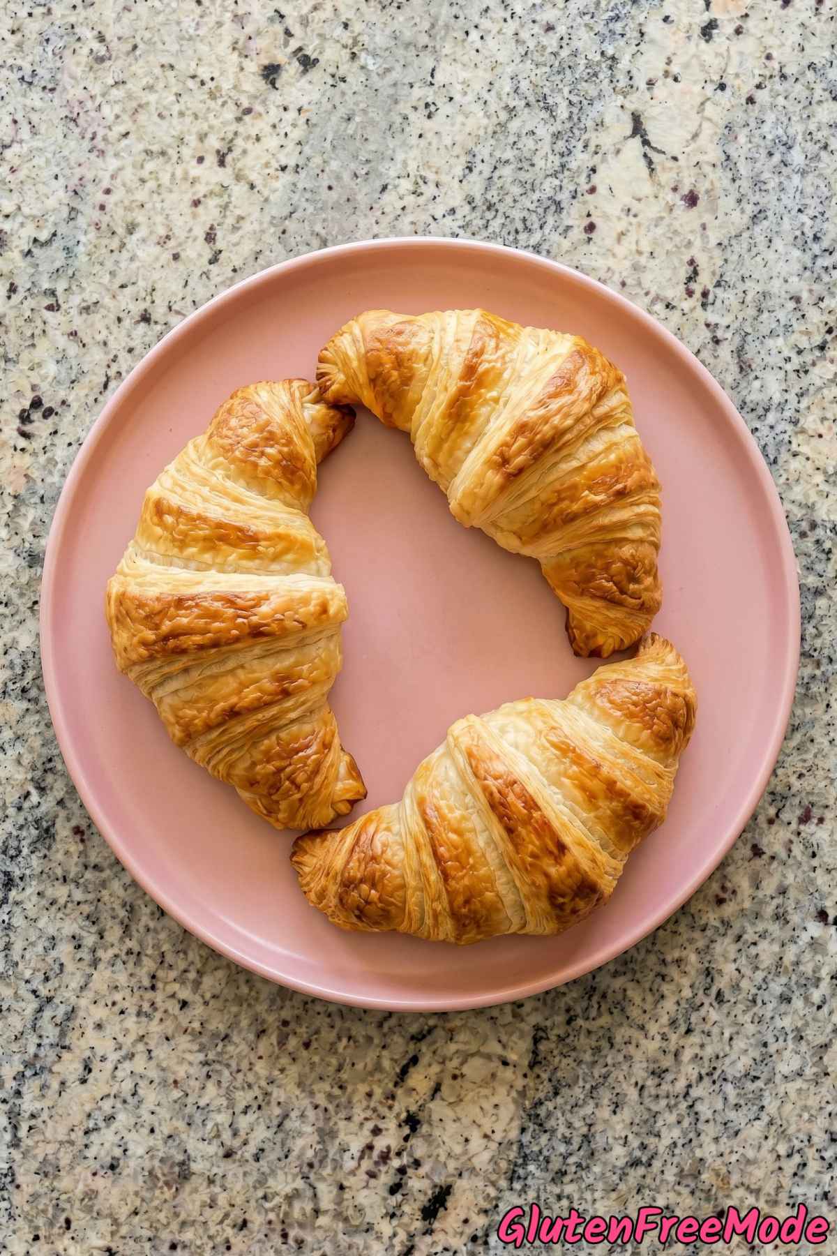 Warm gluten free flaky croissants on plate