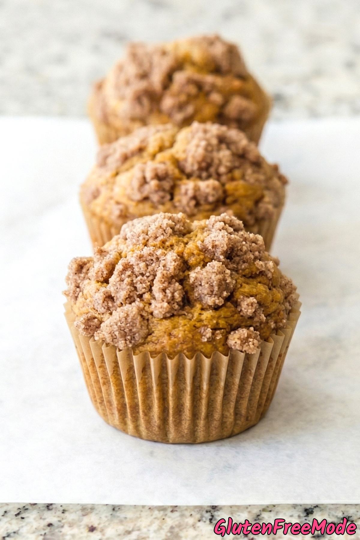 Tender gluten free pumpkin spice muffins stacked