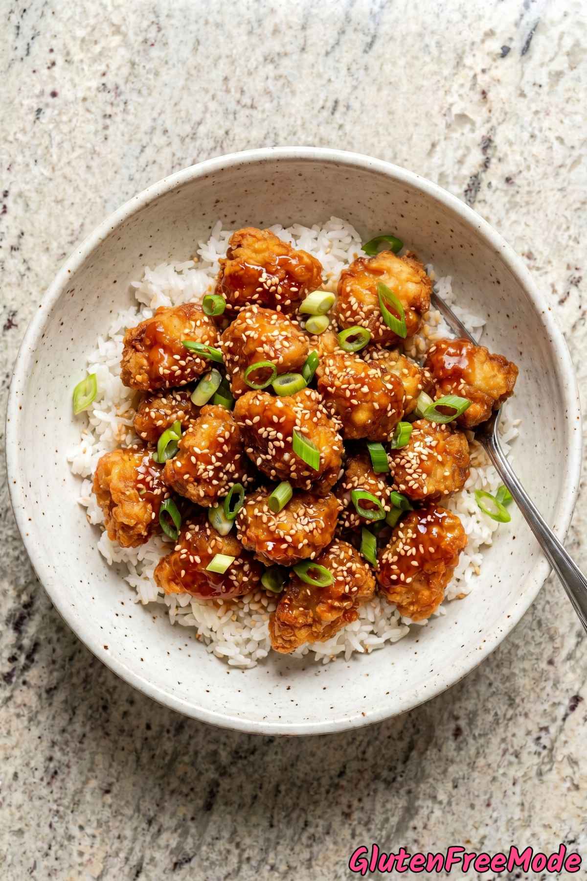 Tender gluten free sesame chicken served