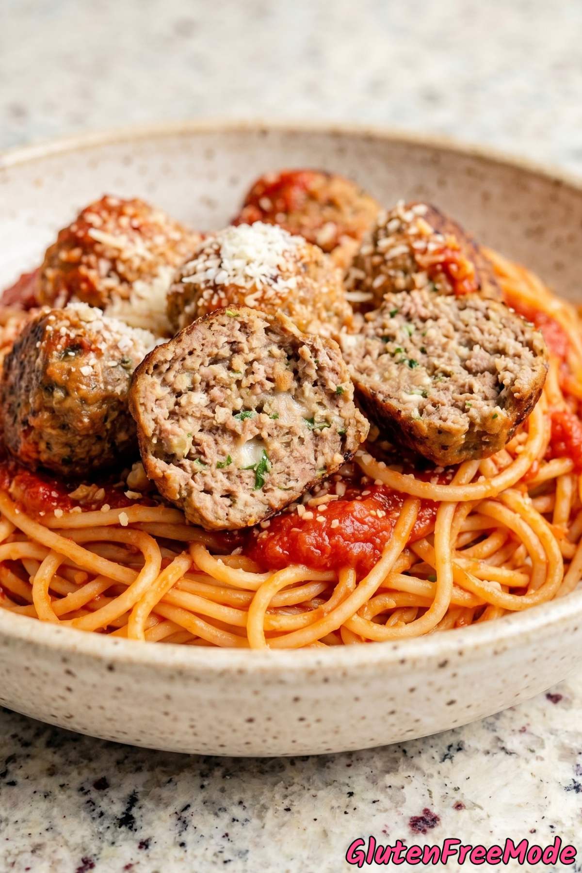 Tender gluten free meatballs over spaghetti